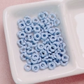 Macro view of light blue wavy flower spacers for DIY jewelry and phone chains - 6.3mm / Blue