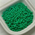 Green rubber-finish round beads for DIY jewelry and necklaces in a white tray - Dark Green
