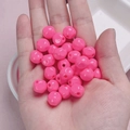 Macro shot of 10mm glossy bright pink acrylic beads held in hand for DIY jewelry making - 10mm / Rose Red