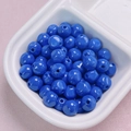 Macro shot of glossy 10mm bright blue acrylic beads in a ceramic tray for DIY jewelry - 10mm / Sapphire Blue