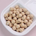 Close-up of 10mm glossy light brown acrylic beads with holes for DIY jewelry making - 10mm / Brown