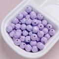 Close-up of 10mm lavender purple acrylic lacquer beads in a ceramic tray for DIY jewelry - 10mm / Purple