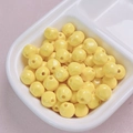Close-up of 10mm bright yellow acrylic beads with glossy finish and center hole for DIY - 10mm / Yellow