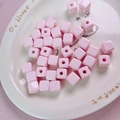 Macro shot of pink square 12mm acrylic beads with center holes for DIY crafts - 12mm / Light Pink