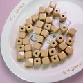 Close-up of 12mm light brown acrylic cube beads with holes for DIY jewelry making - 12mm / Light Coffee