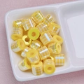 Detail of yellow striped cylindrical resin beads in a ceramic tray for DIY jewelry - Striped Style (02-Yellow) / 10*8.5mm / Yellow