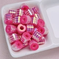 Close-up of pink and white striped cylindrical resin beads with a glossy UV finish - Rose Red