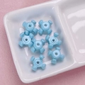 Macro shot of light blue acrylic star beads for DIY jewelry and phone chains - 10x15mm / Blue