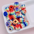 Close-up of colorful striped cylindrical resin beads for DIY jewelry making and crafts - Colorful