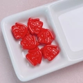 Macro detail of red 3D Darth Vader style DIY charms in a white ceramic organizer tray - Red