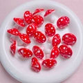 Close-up of red and white polka dot mushroom acrylic beads for DIY jewelry making - Red