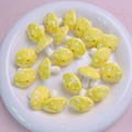 Detailed view of yellow spotted mushroom acrylic beads for handmade DIY jewelry crafting - Yellow