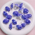 Macro shot of purple mushroom acrylic beads with white dots for DIY jewelry making - Purple