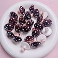 Macro detail of brown polka dot ceramic mushroom beads for handmade jewelry DIY projects - Brown