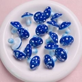 Macro shot of blue polka dot mushroom acrylic beads for handmade DIY jewelry projects - Sapphire Blue