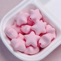 Detailed macro view of pink macaron star acrylic beads in a ceramic bowl for DIY crafts - Light Pink