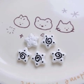 Macro shot of 5pcs star acrylic beads with spiral patterns for DIY jewelry making - White
