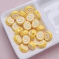 Macro shot of yellow and white acrylic spiral beads for DIY jewelry and keychain making - Size Approx 10x12mm Hole Approx 2mm / Yellow