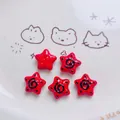 Detail of red acrylic star beads with hand-painted spiral patterns for DIY crafts - Red