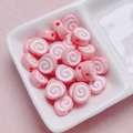Macro shot of pink and white spiral acrylic swiss roll beads for DIY jewelry making - Size Approx 10x12mm Hole Approx 2mm / Pink