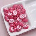 Macro detail of pink and white spiral acrylic beads for DIY jewelry and phone charms - Size Approx 10x12mm Hole Approx 2mm / Deep Pink