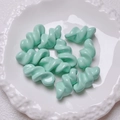 Close-up of mint green spiral acrylic beads for DIY handmade jewelry and craft accessories - 27.5x14mm / Cyan