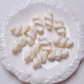 Macro shot of glossy cream-colored spiral acrylic beads for DIY jewelry making - 27.5x14mm / Off White