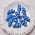 Macro shot of bright blue spiral acrylic beads with a smooth lacquered finish in a tray - 27.5x14mm / Dark Blue
