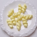 Close-up of cream spiral acrylic beads on white artistic tray for DIY jewelry projects - 27.5x14mm / Light Yellow