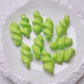 Macro shot of vibrant lime green acrylic twist spiral beads for DIY jewelry making - 27.5x14mm / Green