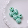 Close-up of mint green pumpkin acrylic beads on a white plate for DIY jewelry projects - Size approx 14.5*15.5mm, aperture approx 3.5mm (Single Piece) / Cyan