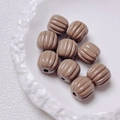 Macro detail of khaki pumpkin-shaped acrylic beads with ribbed texture for DIY crafts - Size approx 14.5*15.5mm, aperture approx 3.5mm (Single Piece) / Coffee