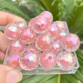 Close-up of pink iridescent faceted round beads in a tray for jewelry making - 1 Piece/Pack (16mm) / Orange