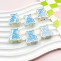 Detail of DIY jewelry beads showing six colorful bear charms with a pearlescent finish - Floral Pattern Bear