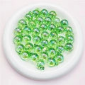 Detail view of emerald green UV coated candy beads with hanging loops for DIY jewelry - 16mm / Transparent Green