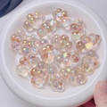 Macro view of colorful UV plated cloud beads with shimmering finish in a white plate - 22x32mm (Sold by Piece) / Orange