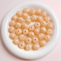 Macro shot of peach acrylic beads with glitter and yellow heart patterns in a white bowl - 16mm / Grapefruit Color