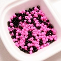 Detailed macro view of 4mm pink and black glass seed beads in a square white tray - (Sold by Pack/Approx 200 Pcs) Diameter 4mm Hole 1.2mm / 07