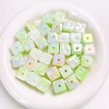 Macro view of luminous cube beads in light green with iridescent star-like coating - Approx 14.5 Diameter (Sold per Piece) / Glow Green