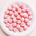 Macro detail of glossy pink resin spiral beads for DIY jewelry and phone chains - Diameter 16mm Hole 3mm / Pink