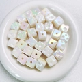 Close-up of Aurora cube spacer beads with pearlescent finish and star-engraved details - Approx 14.5 Diameter (Sold per Piece) / Glow White