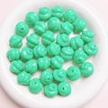 Macro detail of mint green spiral twisted beads for DIY jewelry and phone chains - Diameter 16mm Hole 3mm / Cyan