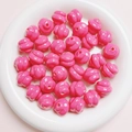 Macro view of bright pink spiral craft beads for DIY jewelry making in a white tray - Diameter 16mm Hole 3mm / Rose Red