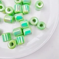 Macro detail of glossy light green iridescent acrylic barrel beads for DIY jewelry making - Diameter approx 16mm Hole approx 6mm / Iridescent Green