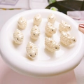 Macro detail of 10-piece cream white sheep-shaped cartoon beads for DIY jewelry making - Yellow Sheep