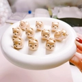Close-up of ten cartoon Shiba Inu ceramic beads with glossy UV coating on a white tray - Brown Dog