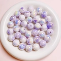 Nahaufnahme von leuchtenden Acrylperlen in Perlweiß und Lila für DIY-Schmuckprojekte - 16mm Perle / Lila