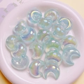 Close-up of holographic blue moon-shaped resin beads for DIY jewelry making - 22x25mm / Light Green