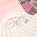 Macro shot of iridescent aurora crescent moon beads on a white textured display tray - 22x25mm / Clear White