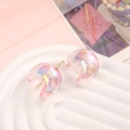 Detailed close-up of crescent moon beads with iridescent pink coating on a white tray - 22x25mm / Transparent Pink